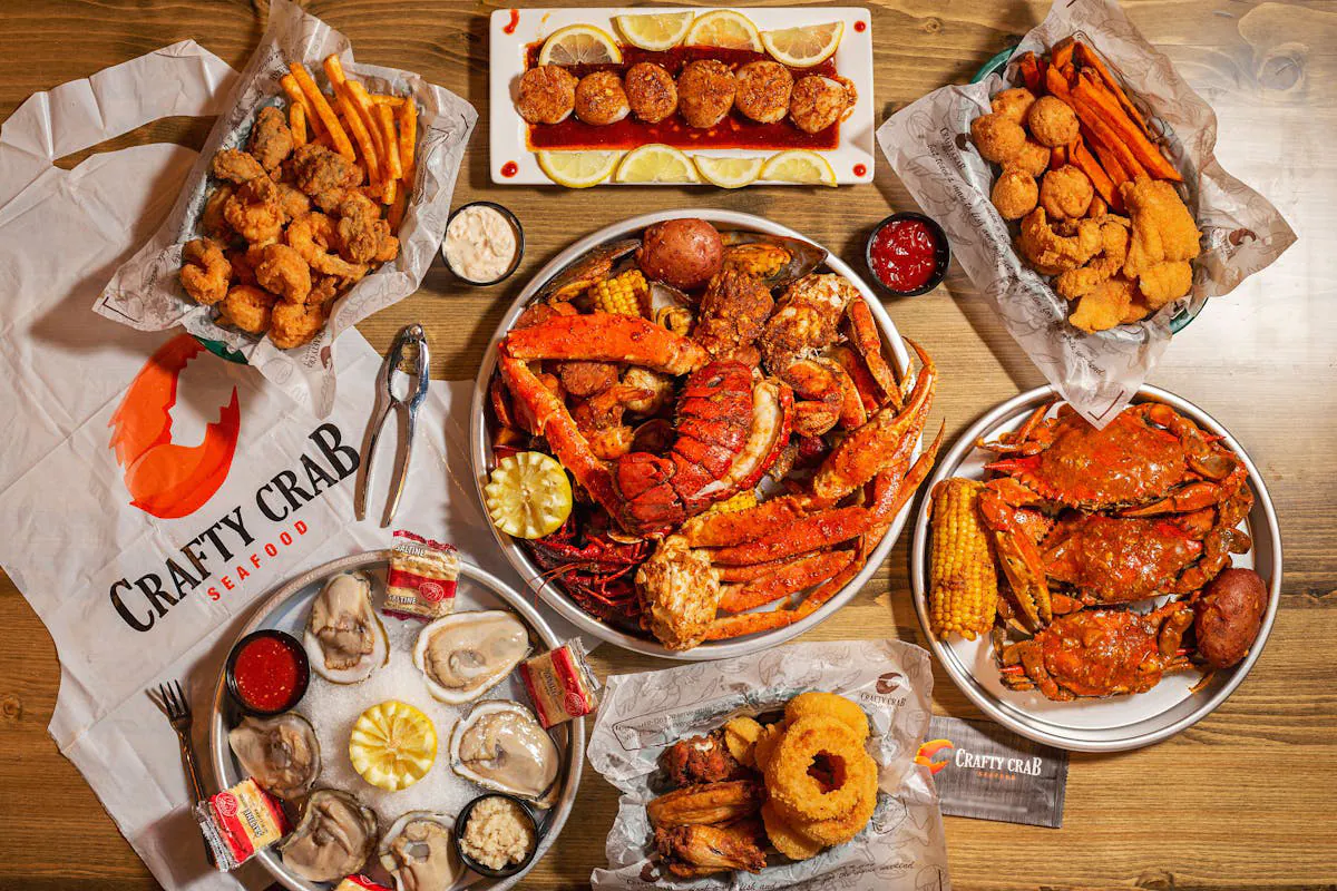 Overhead view of seafood spread with crab, shrimp, oysters, and sides at Crafty Crab, a Seafood Restaurant in Wilmington